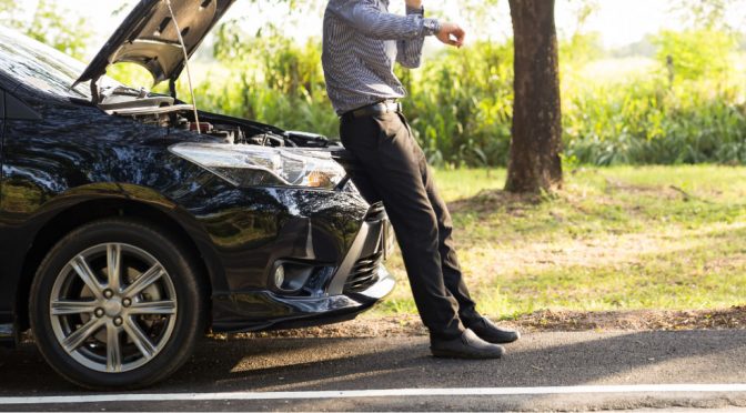 Man Sitting on Car