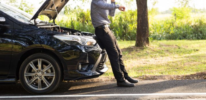 Man Sitting on Car